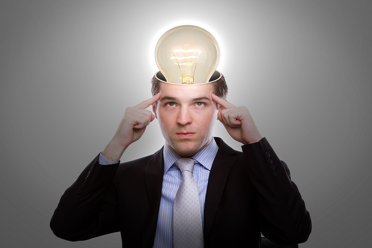 Portrait of young business man thinking with light bulb out from